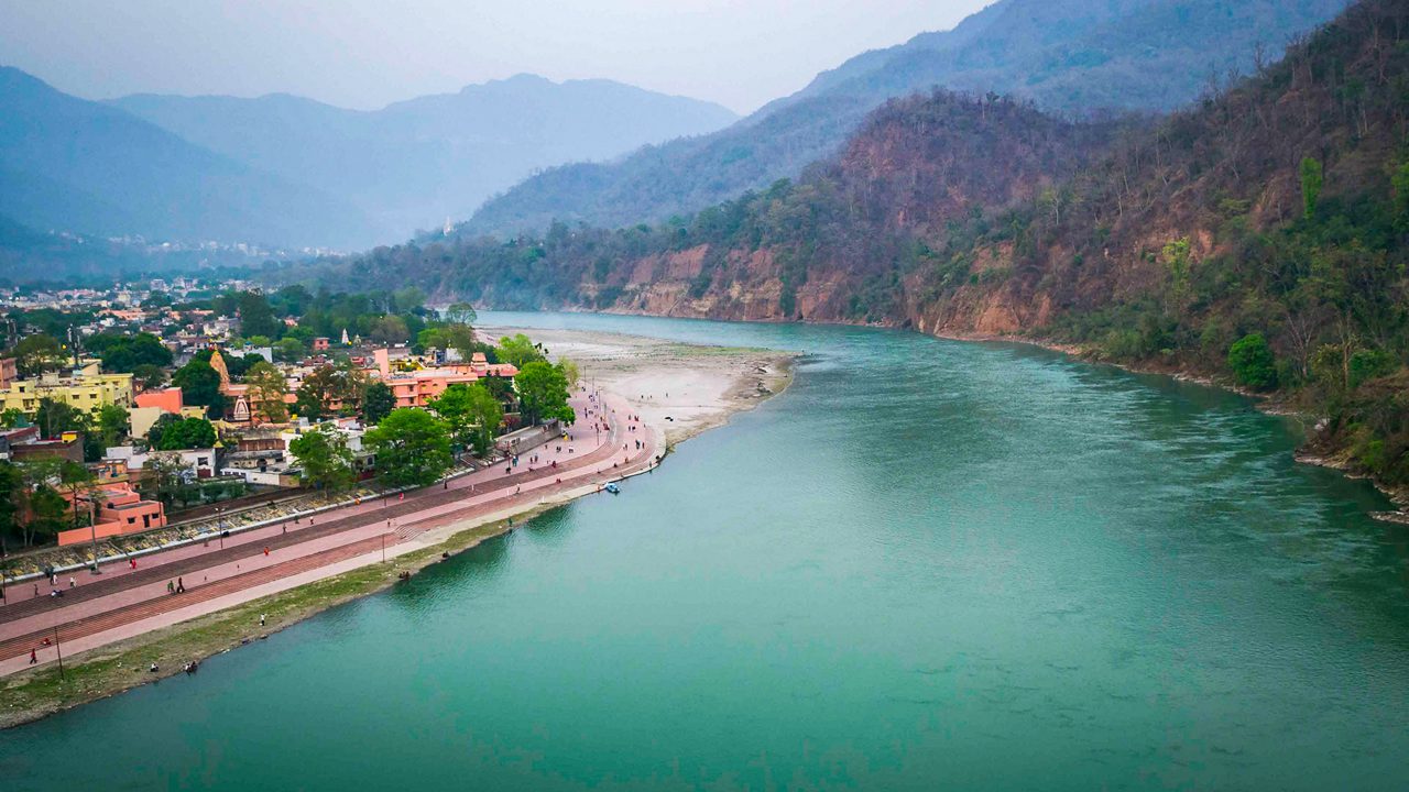 Ganges River flowing through Rishikesh with mountains