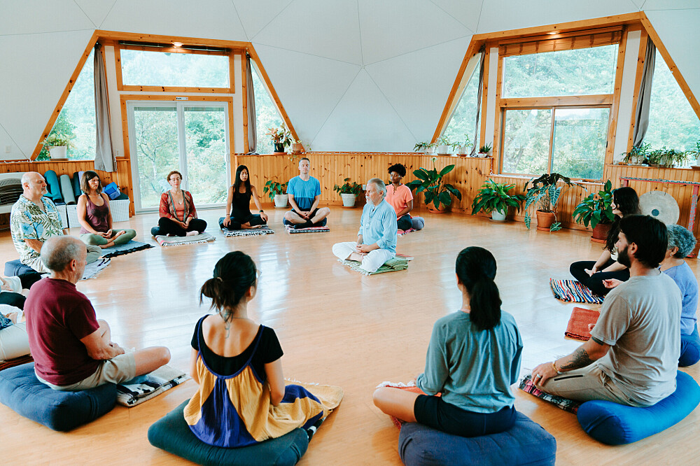 Group meditation circle in beautiful dome space