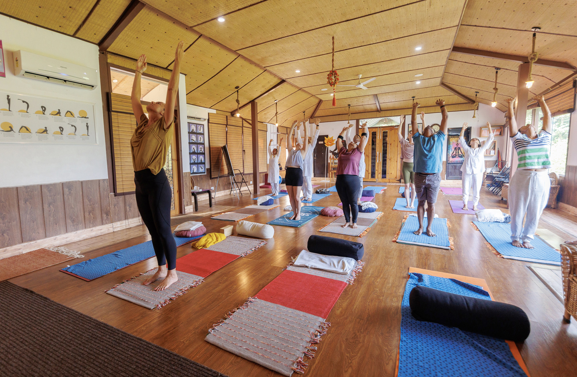 Group yoga practice in traditional hall